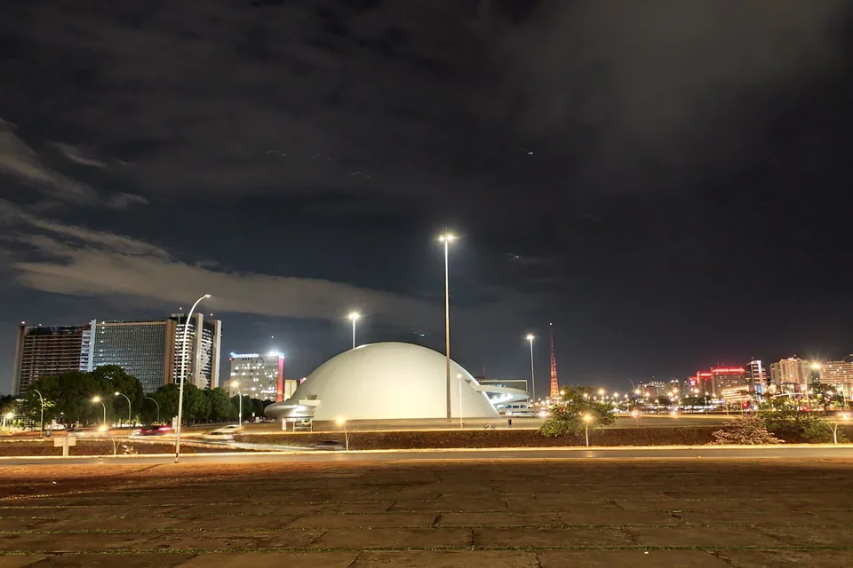 Cúpula branca do Museu Nacional da República iluminada à noite, em Brasília
